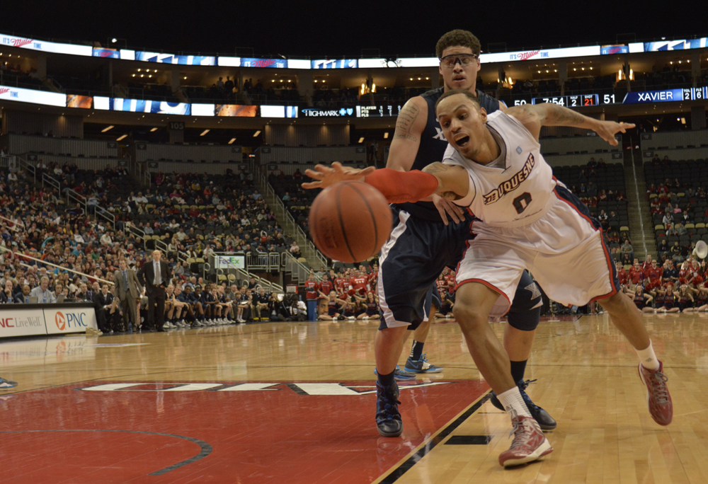Connor Hancovsky / For The Duquesne Duke | Andre Marhold attempts keep the ball inbounds as the Dukes lose to Xavier, 73-65, Saturday evening at the Consol Energy Center. The Dukes have lost 11 straight games.