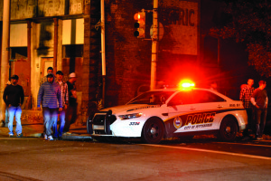 Photo by Taylor Miles | The Duquesne Duke. A Pittsburgh Police car flashes its lights on Saturday night in South Side. Since “saturation detail” was instituted, crime and 911 calls have decreased, according to police.