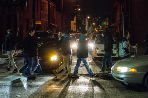 Photo by Aaron Warnick | Photo Editor. A group of walkers cross the street Saturday night on East Carson Street in South Side. The city of Pittsburgh, in collaboration with the Responsible Hospitality Institute, is implementing new procedures to make the neighborhood safer at night. 