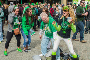 Photo by Aaron Warnick | Photo Editor. Parade-goers dance, drink and party in the streets of Pittsburgh during the 114th annual St. Patrick’s Day Parade.