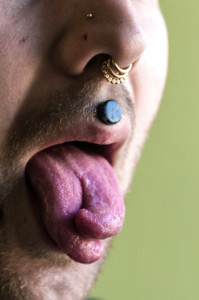 (Aaron Warnick / Photo Editor)- The split tongue and other facial piercings of Twitch