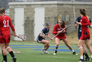 Claire Murray | Asst. Photo Editor Freshman attackman Kaitlyn DeHaven manuevers toward the net in the offensive zone in the Dukes’ victory over Robert Morris.
