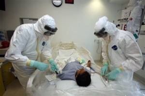 AP Photo. Doctors participate in an exercise on diagnosing and treating patients with Ebola virus symptoms at the Ronald Reagan UCLA Medical Center in Los Angeles.