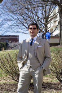 (Fred Blauth / Editor-in-Chief) Sophomore international relations major Nick Santini displays a beige suit, complemented by a pop of color from his blue shirt. A pair of vintage-style shades complete the look.
