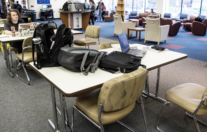 (Claire Murray/Photos Editor) A table in Gumberg Library sits occupied by belongings but unused by students.