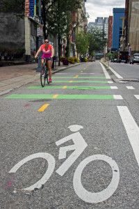 (Claire Murray/Photo Editor) A cyclist rides on the Penn Avenue bike lane. Bike counting sensors have been placed at three different spots throughout Penn Avenue to monitor bicycle traffic along the route. 