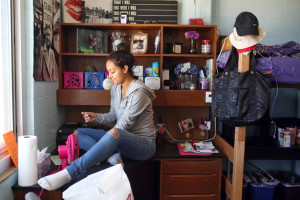 Somer Gaines, left, a first generation college student, puts the finishing touches on her dorm room at the University of Nebraska-Lincoln by hanging up a Marilyn Monroe poster in Smith Hall Dormitory on Monday, Aug. 24, 2015 in Lincoln, Neb. Somer participated in a new orientation program for first generation student prior to the star of school. (Jenna Vonhofe/Lincoln Journal Star via AP)
