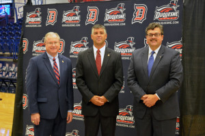 Harper (center), stands alongside Charles Dougherty (left) and John Plante (right) at the athletic director’s introductory press conference Tuesday morning ainside the A.J. Palumbo Center.