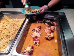 By Kaye Burnet | News Editor An employee serves Chicken Marsala to students in the Sean Hogan Dining Hall.