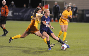 Courtesy of Athletic Department Freshman midfielder Abby Losco attempts to shake off a WVU defender in the Dukes’ 4-0 loss to the Mountaineers last Friday night. This was Duquesne’s first NCAA tournament appearance. 
