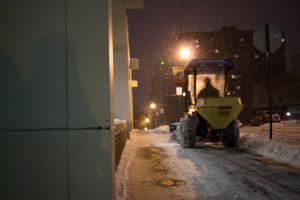 Photo by Seth Culp-Ressler | Features Editor. A snowplow-equipped tractor clears snow in front of the Union early Saturday. Twenty-five employees worked to ready campus for the day.