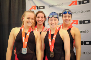 Courtesy of the Atlantic 10 - (Left to right) Former Duquesne swimmer Line Loveberg, sophomore Lexi Santer and seniors Sam Ray and Claire Nobels pose after the 2015 Atlantic 10 swimming championships.  
