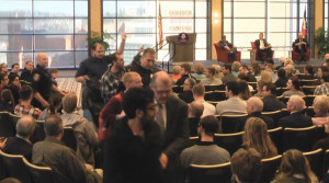 Screenshot taken from the live footage of the event provided by Duquesne Media Services Four protesters are escorted out of the Duquesne Power Center Ballroom by police after protesting against General Michael Hayden, who was giving a speech on campus Tuesday afternoon.