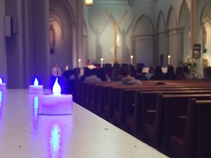 Kaye Burnet/ News Editor Blue candles illuminate the campus chapel Wednesday during a mass for childhood grief awareness. On April 20, a Duquesne social justice class will host child grief awareness events, including dyeing the campus fountains blue.