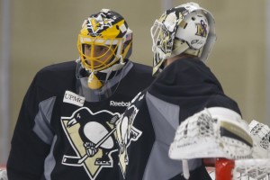 Pittsburgh Penguins goalie Marc-Andre Fleury, left, talks with goalie Jeff Zatkoff during a practice session for the NHL hockey playoffs against the New York Rangers, Monday, April 11, 2016, at their practice facility in Cranberry, Pa. (AP Photo/Keith Srakocic)