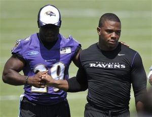 AP Photo Rice, right, walks off the field before addressing media at a news conference. 