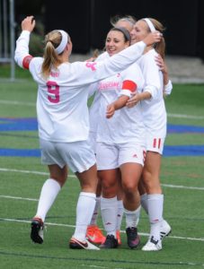 Senior midfielder Maddie Layman, junior forward Linnea Faccenda and freshman forward Katie O’Connor celebrate a goal in their 2-0 win over Davidson on Oct. 9 at Rooney Field in Pittsburgh. 