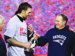 New England Patriots quarterback Tom Brady, left, holds the AFC Championship trophy as he celebrates with head coach Bill Belichick after the AFC championship NFL football game, Sunday, Jan. 22, 2017, in Foxborough, Mass. The Patriots defeated the the Pittsburgh Steelers 36-17 to advance to the Super Bowl. (AP Photo/Matt Slocum)
