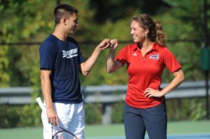 Courtesy of Duquesne Athletics | Junior Andrew Ong and Director of Tennis Vanessa Steiner share a fist bump during fall practice as they look to solidify the men’s tennis team.