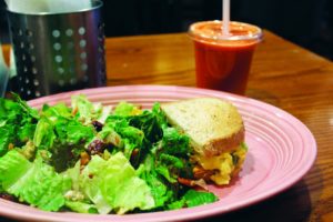 Nina Saluga | Staff Writer A fruit and nut salad and mesquite turkey sandwich with a “Sunrise Suzy” from Red Oak Cafe.