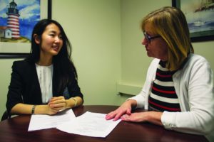 Sydney Bauer | Staff Photographer Internship Coordinator Linda Loewer helps a student with her résumé at the Career Services office.