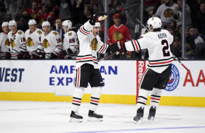FILE - In this Nov. 28, 2015, file photo, Chicago Blackhawks right wing Patrick Kane, left, celebrates his goal with defenseman Duncan Keith during the first half of an NHL hockey game against the Los Angeles Kings in Los Angeles. Kanes second-period goal against Minnesota on Tuesday, Dec. 1, extended his point streak to 20 games, one shy of the franchise record set by Hall of Famer Bobby Hull during the 1971-72 season. (AP Photo/Mark J. Terrill, File)